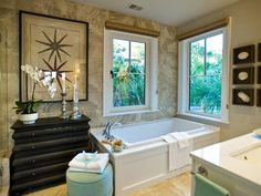 a bathroom with two windows and a bathtub