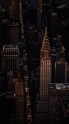 an aerial view of skyscrapers at night in new york city, with the lights on