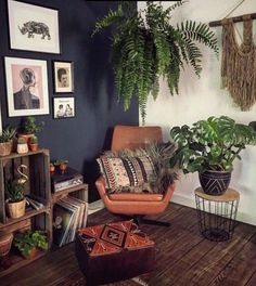 a living room filled with furniture and lots of plants on top of wooden flooring