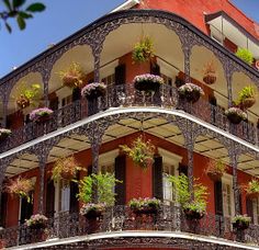 an ornate building with balconies and flowers on the balconies is shown