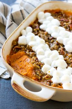 a casserole dish with marshmallows and other toppings in it