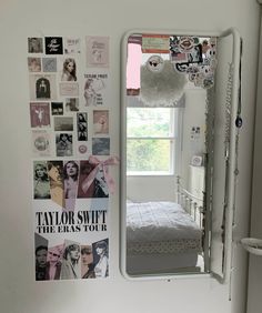 a bedroom with a bed and a large mirror on the wall above it that says taylor swift the easys tour