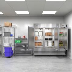 an industrial kitchen with stainless steel refrigerators and shelves