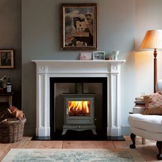 a living room with a chair and a fire place in the middle of the room