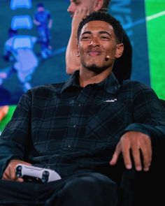 a man sitting in a chair smiling at the camera