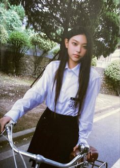 a woman with long hair riding a bike