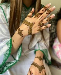 a woman with henna tattoos on her hands