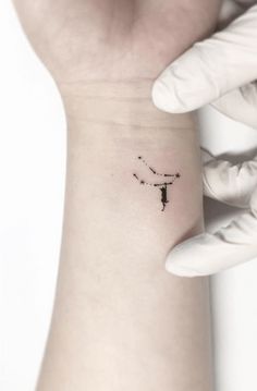 a person with a small tattoo on their wrist