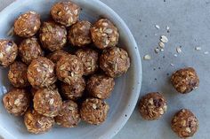 a white bowl filled with chocolate and oatmeal balls