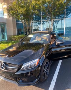 a black car parked in front of a building