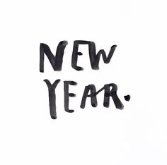 the word new year written in black ink on a white background