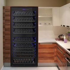 a wine cooler in the middle of a kitchen