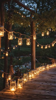 mason jar lights are strung on the wooden deck