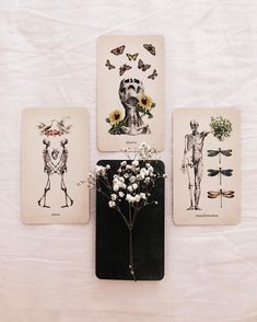 three cards with pictures of people and flowers on them, one has a skeleton in the middle