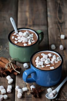 two mugs filled with hot chocolate and marshmallows