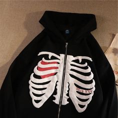 Upgrade your wardrobe with our women's skeleton zip up emo oversized hoodie. featuring a trendy emo-style design with a unique skeleton print and a comfortable oversized fit, this hoodie is perfect for any occasion. Bleach Skeleton Hoodie Tutorial, Y2k Skeleton, Skeleton Hoodie, Skull Sweater, Streetwear Fits, Streetwear Mode, Edgy Chic, Letter Print Hoodie, Retro Mode