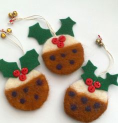 three felt ornaments with holly and berries on them