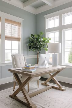 a laptop computer sitting on top of a wooden desk next to a plant in a vase