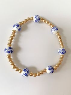 Blue Floral gold beaded bracelet Adjustable Gold-tone Metal Beaded Bracelet, Dainty 14k Gold-filled Bracelets With Colorful Beads, Adjustable Gold-plated Beaded Bracelets, Beaded Gold Metal Jewelry, Gold-tone Metal Jewelry With Round Beads, Elegant Metal Beaded Bracelet With Gold Beads, Gold Metal Jewelry With Round Beads, Elegant Metal Beaded Bracelets With Gold Beads, Dainty Blue Round Bead Bracelets