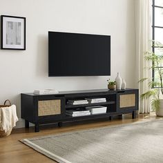 a flat screen tv mounted to the side of a wooden entertainment center in a living room