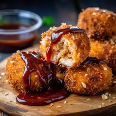 some food is sitting on a cutting board with sauce and ketchup in the background