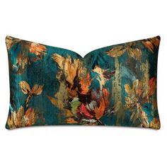 a blue and orange floral pillow on a white background with an image of birds in flight