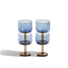 three blue glasses sitting on top of each other