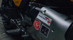 the front end of a motorcycle with stickers on it