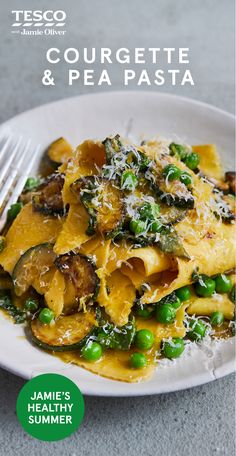 a white plate topped with pasta and peas