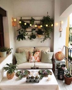 a living room filled with furniture and lots of potted plants on top of it