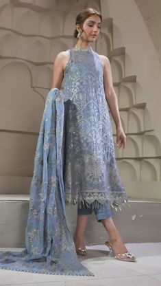 Elegant Blue Short Shirt with Capri Pakistani Party Wear Curated in a wonderful blue tone, blue bell embraces a perfection in its subtle embroidery and sequins work. Paired with a floral design dupatta and a tonal trouser this ensemble is a step towards slaying this season. A stellar piece curated on a navy blue lawn base painstakingly worked in shades of gray & ash white thread is topped with silver spangles & zari creating a floral pattern for the front. Detailed Description: SKU: PB0033 Detai Designer Blue Sequined Sets, Elegant Designer Dupatta With Sequins, Elegant Unstitched Summer Suit With Resham Embroidery, Blue Sequined Sets For Diwali, Blue Sequin Sets For Diwali, Blue Tissue Silk Dress For Party, Blue Sequined Party Wear Sets, Blue Tissue Silk Party Dress, Designer Blue Sequined Salwar Kameez