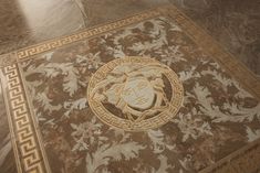 the floor is decorated with intricate designs and gold trimmings, along with a lion's head