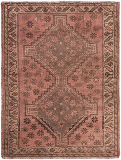 an antique rug with pink and brown colors