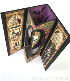 the inside of an open halloween card box with bats and skulls on it's sides