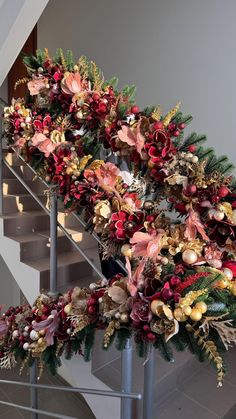 a christmas wreath on the top of a stair case