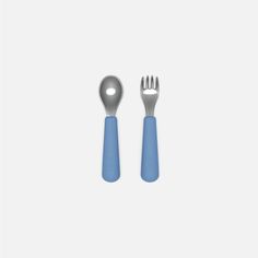 two forks and a spoon on a white surface