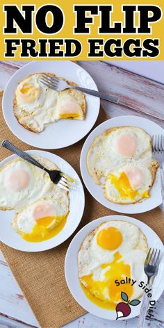 three white plates topped with fried eggs on top of a wooden table next to silverware