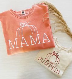 MAMA & MINI HALLOWEEN SWEATSHIRTS/TEES PICTURED: Mama Sweatshirt in PUMPKIN with white vinyl, Mini Sweatshirt in SAND with texas orange vinyl This MAMA & MINI bundle is such a fun way to match your little this Fall/Halloween! They are also an incredible, heartfelt gift :) PRICING: The item pricing goes as follows and will include TWO items (MAMA and MAMA'S PUMPKIN) - sweatshirt & sweatshirt - $75 CAD - sweatshirt & tshirt - $65 CAD - tshirt & tshirt - $50 CAD TEXT COLOUR: We will print your tran Fall Family Matching Crew Neck Tops, White Family Matching Sweatshirt For Fall, Family Matching Cotton Sweatshirt For Fall, Fall Mommy And Me Shirts, Mom And Me Halloween Shirts, Fall Mama Sweatshirts, Mama And Mini Fall Shirts, Mama Mini Sweatshirt, Mama Pumpkin Shirt