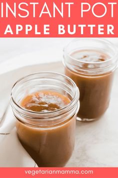 two jars filled with peanut butter sitting on top of a table