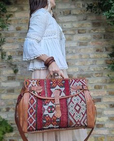 "🌟 Get ready to explore the world with our Customized Large Leather Weekender Bag for Women; a large duffle bag in boho style, handcrafted from upcycled vintage Moroccan carpet!🌟  This vintage style large leather weekender bag for women makes a unique gift for avid travellers and wanderlust girls. Combining traditional Moroccan crafts with modern elegance and practicality, this custom leather travel bag is like no other. It has been handcrafted from true vintage kilim carpets that have been up Travel Duffle Bag With Detachable Shoulder Handle, Travel Bag With Detachable Handle, Brown Travel Bag With Top Carry Handle For Trips, Brown Rectangular Duffle Bag With Detachable Handle, Travel Tote Duffle Bag With Detachable Handle, Red Travel Bag With Leather Handles, Rectangular Travel Luggage With Detachable Handle, Brown Weekender Bag With Detachable Handle For Travel, Travel Satchel Briefcase