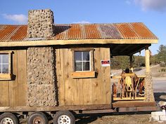 a small wooden cabin sitting on top of a trailer