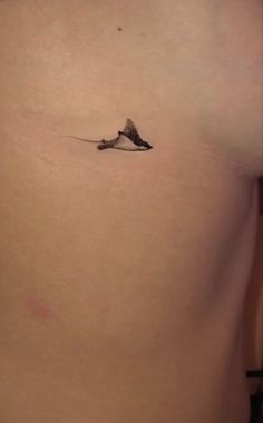 a small tattoo on the back of a woman's stomach