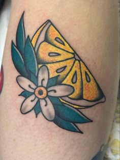 a close up of a tattoo with a butterfly on it's thigh and flowers