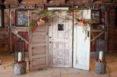 an old door is decorated with flowers and candles