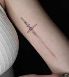 Dual Tattoo Ideas, Fantasy Minimalist Tattoo, Symmetrical Wrist Tattoo, Longsword Tattoo, Dark Fantasy Tattoo Ideas, Dagger Tattoo Placement, Dagger Spine Tattoo, Wrap Around Arm Tattoo For Women, Small Dagger Tattoo