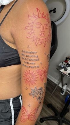 a woman's arm with a sun and flowers tattoo on the back of her shoulder