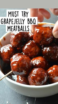 a white bowl filled with meatballs covered in bbq sauce and toothpicks