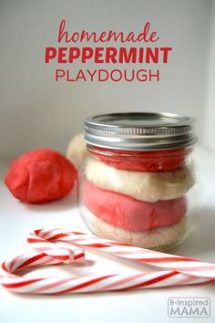 homemade peppermint playdough in a jar with candy canes on the side