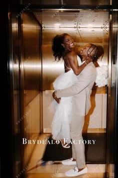 a man and woman kissing in an elevator