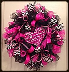 a pink and black wreath on the front door